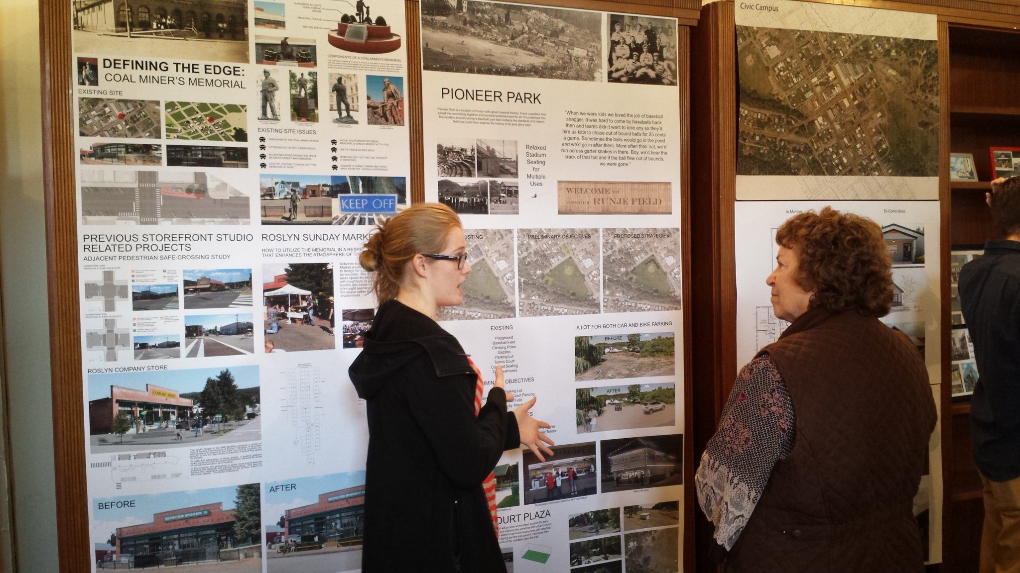 A student gives a presentation in front of posters