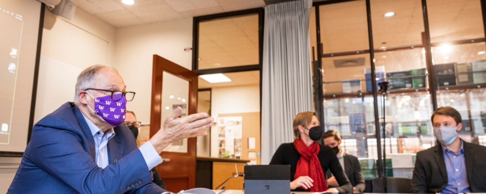 Governor Inslee sitting at table with faculty