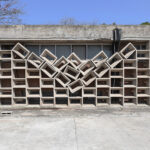 Exterior of a building with stacked concrete blocks and the middle in the shape of a V