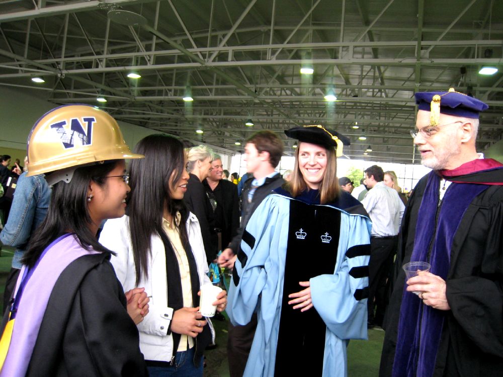 Steve Goldblatt, Carrie Dossick, and two students wearing their graduation attire