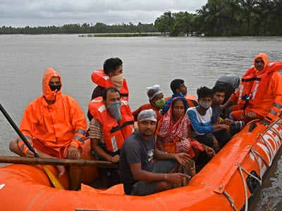 A group of people in bright orange life vests in a raft
