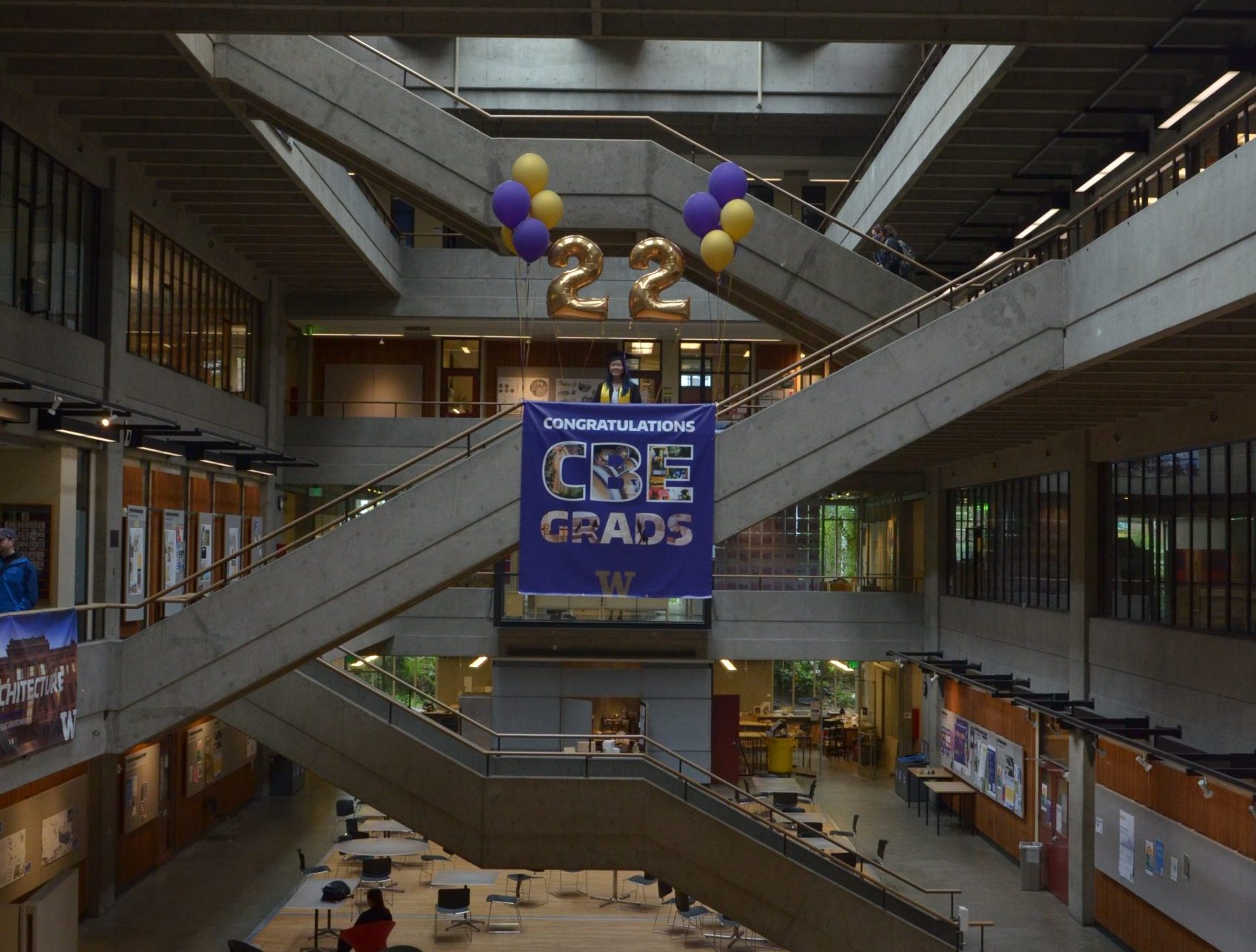 Number 22 balloons and sign that reads congratulations CBE grads hanging in Gould Hall