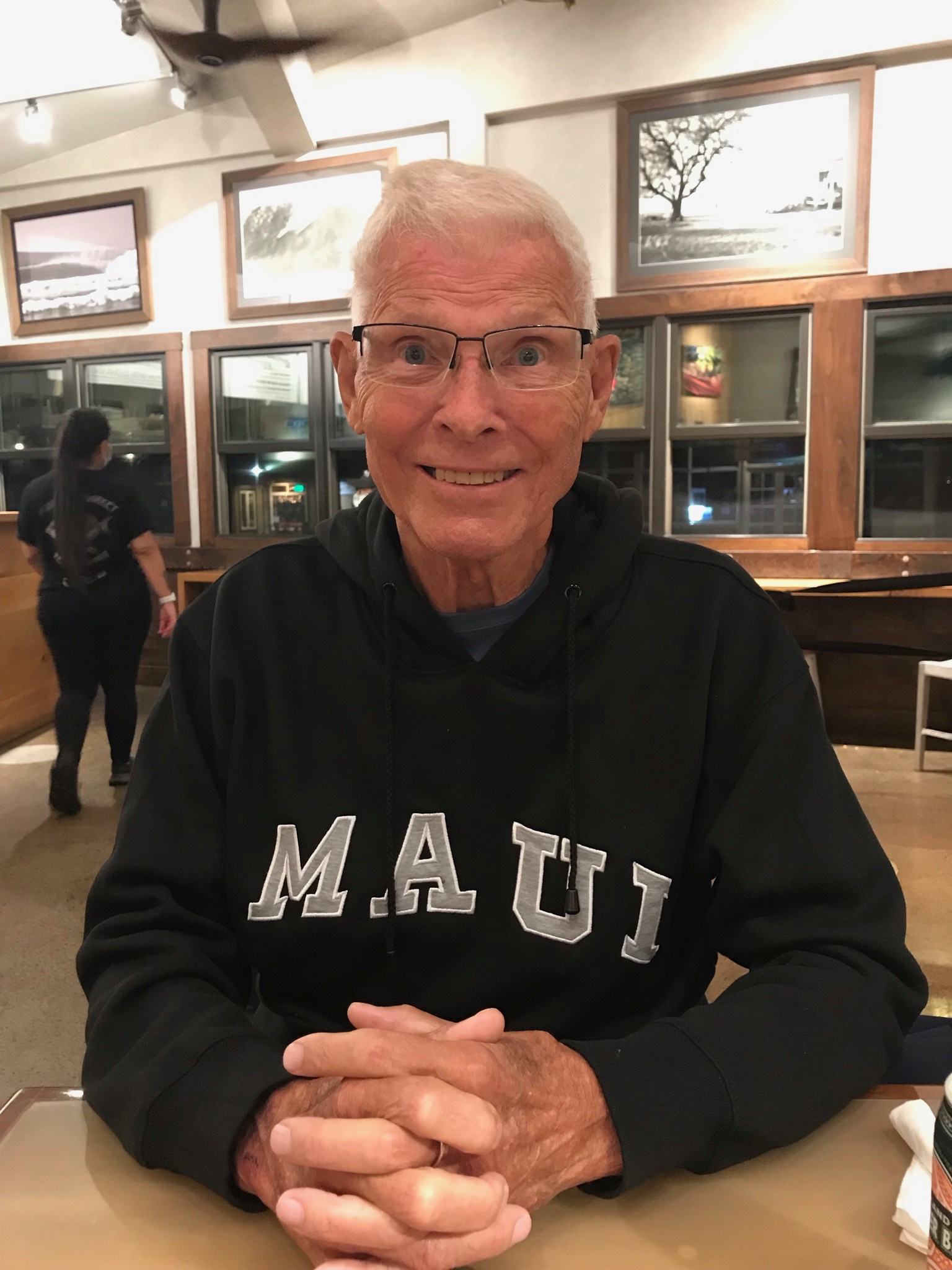 Bob smiling at the camera wearing a sweatshirt that says 'Maui'