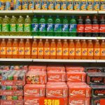 Soda bottles and cans on the store shelves