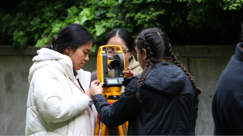 Students using surveying equipment