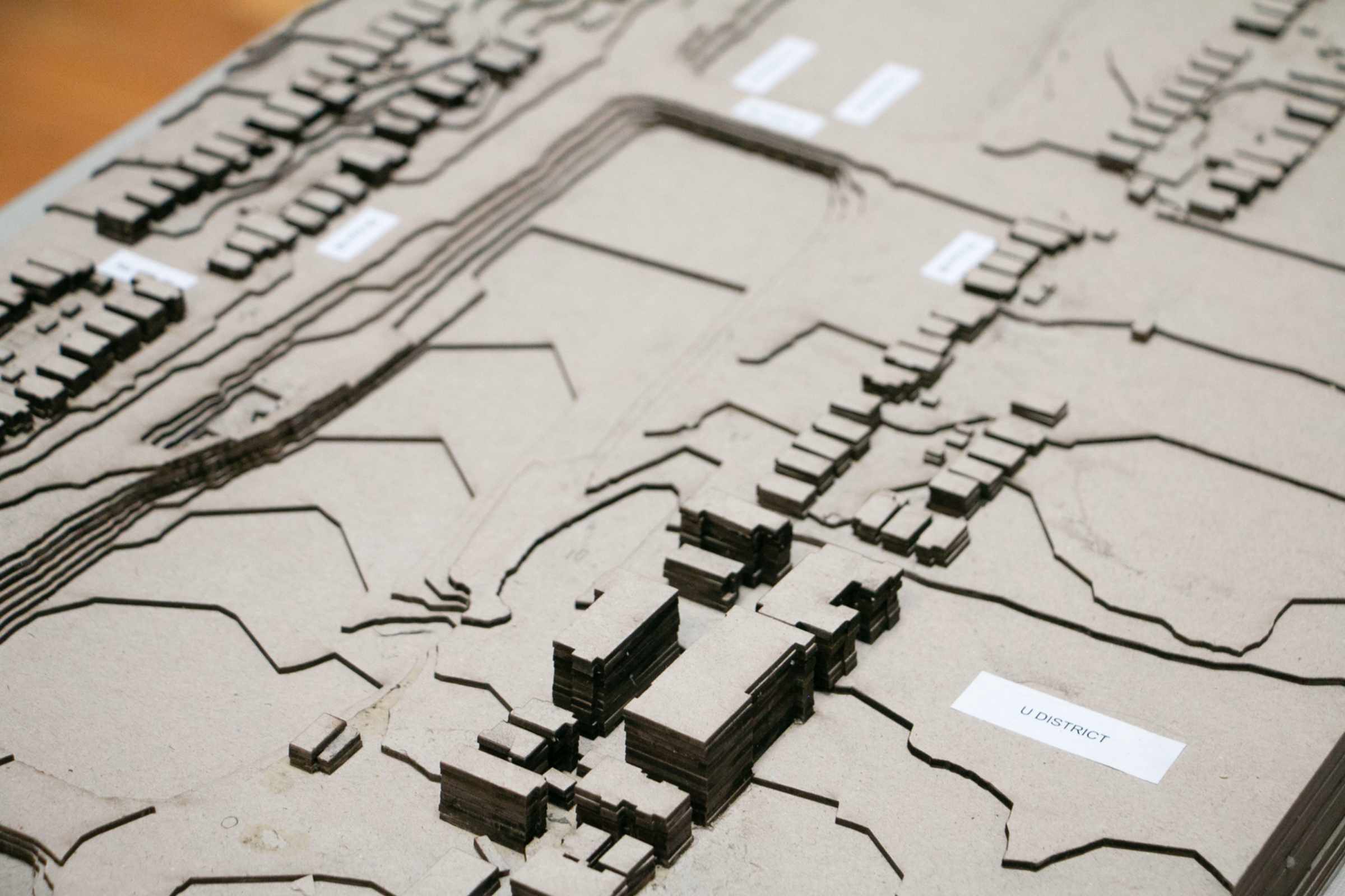 Detailed model of an urban planning project displaying the layout of a district with labeled buildings and streets, capturing the essence of city design.