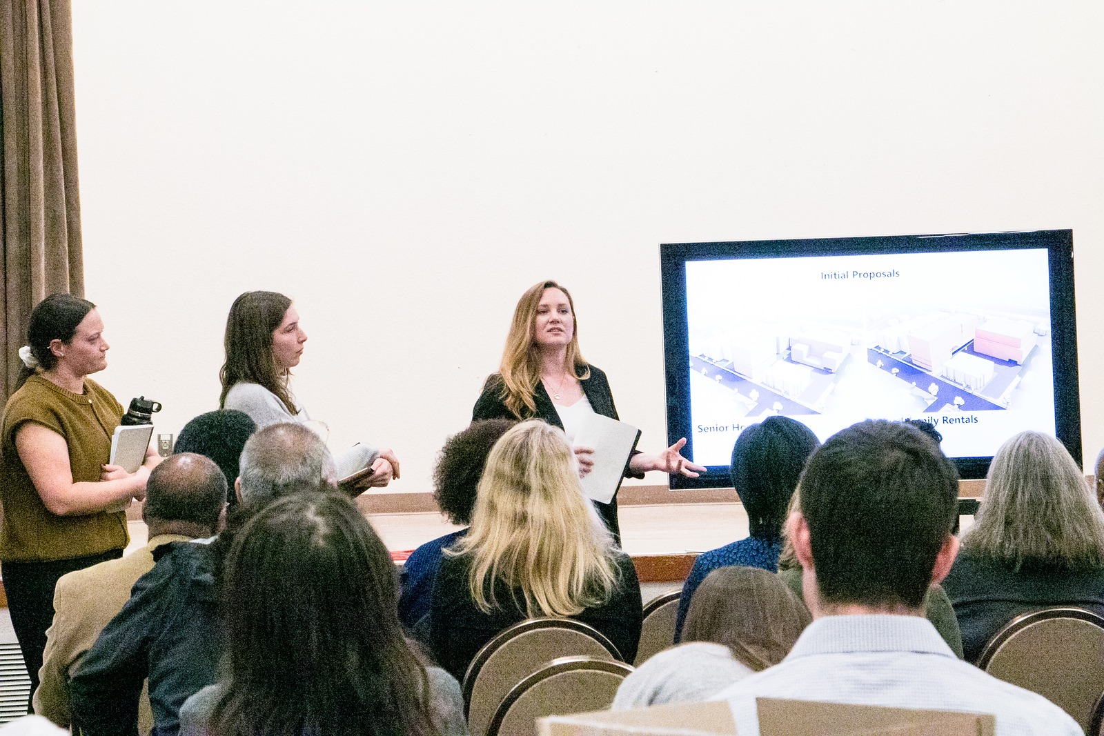 Student presenting housing proposals in front of audience