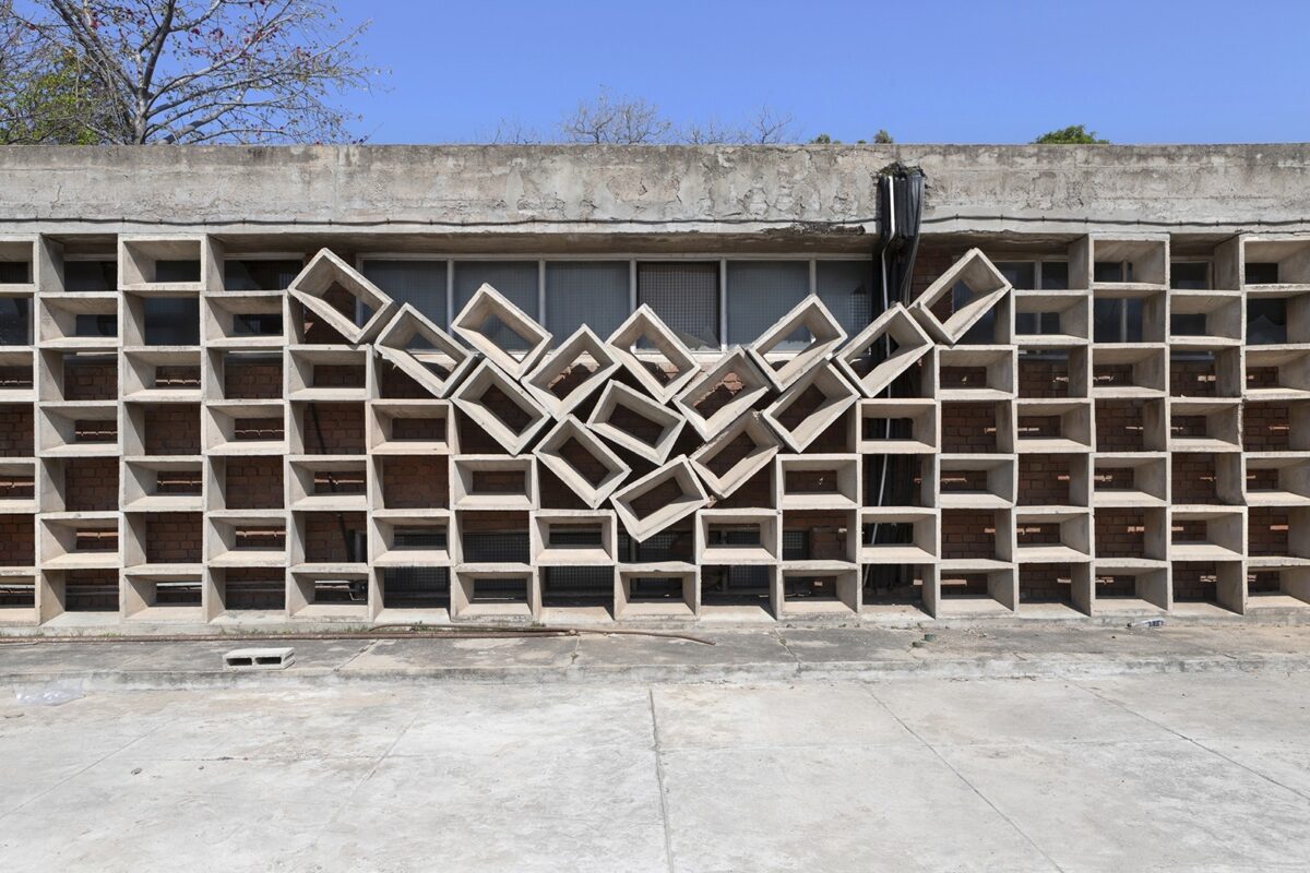 Exterior of a building with stacked concrete blocks and the middle in the shape of a V