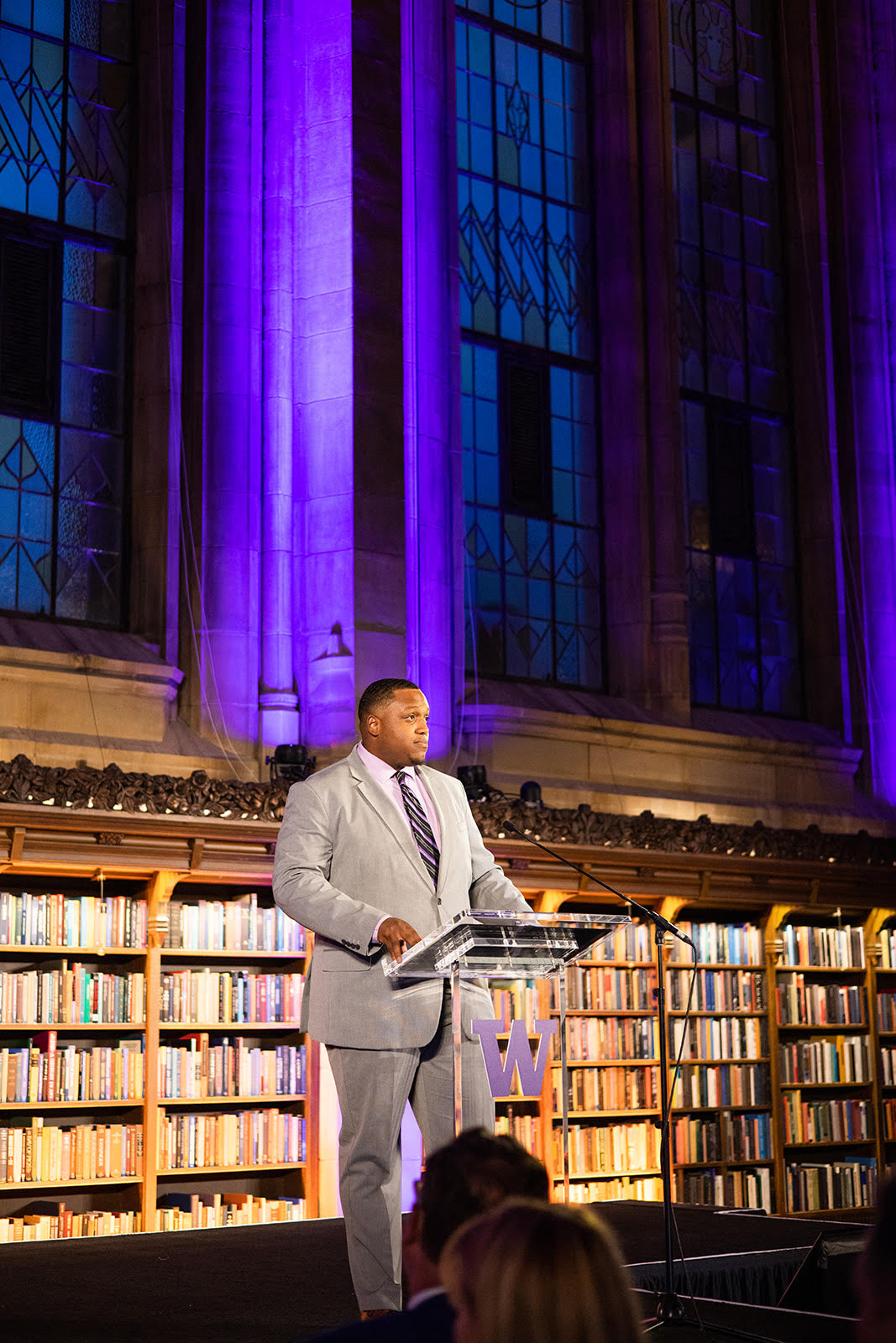 Elijah Mason standing at a podium speaking at an event