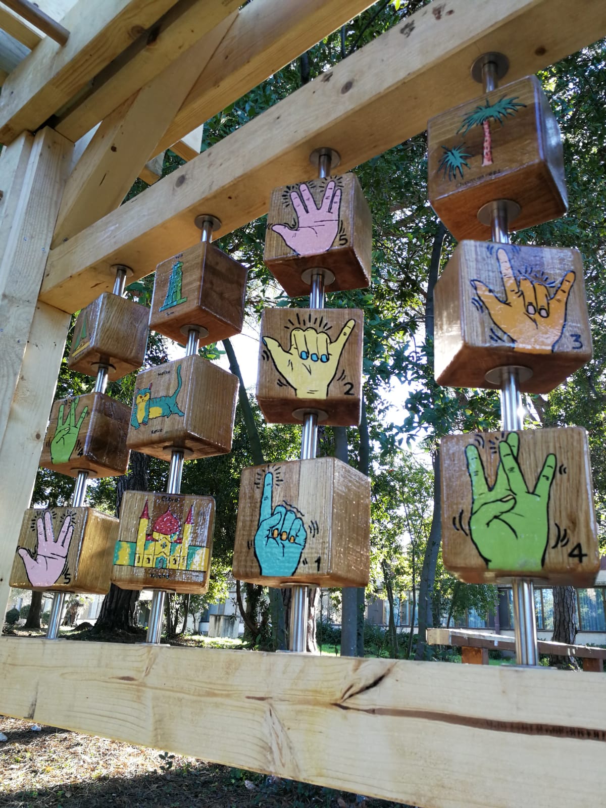 A memory game made of wood blocks on metal poles with hand painted images