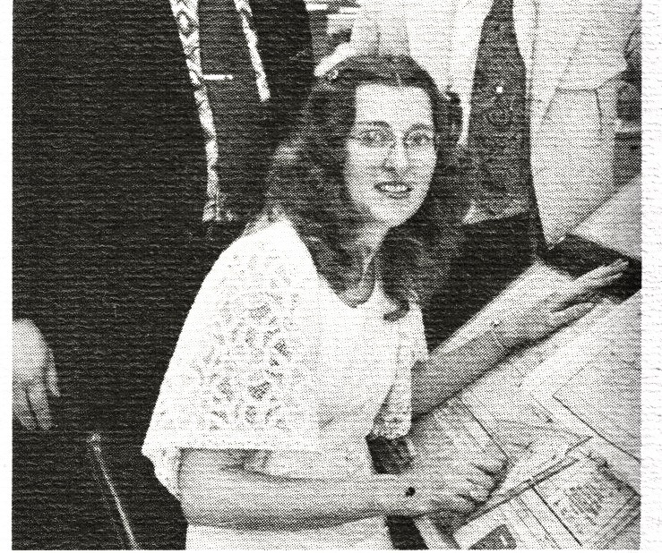 A black and white photo of Darlene sitting at a drafting table