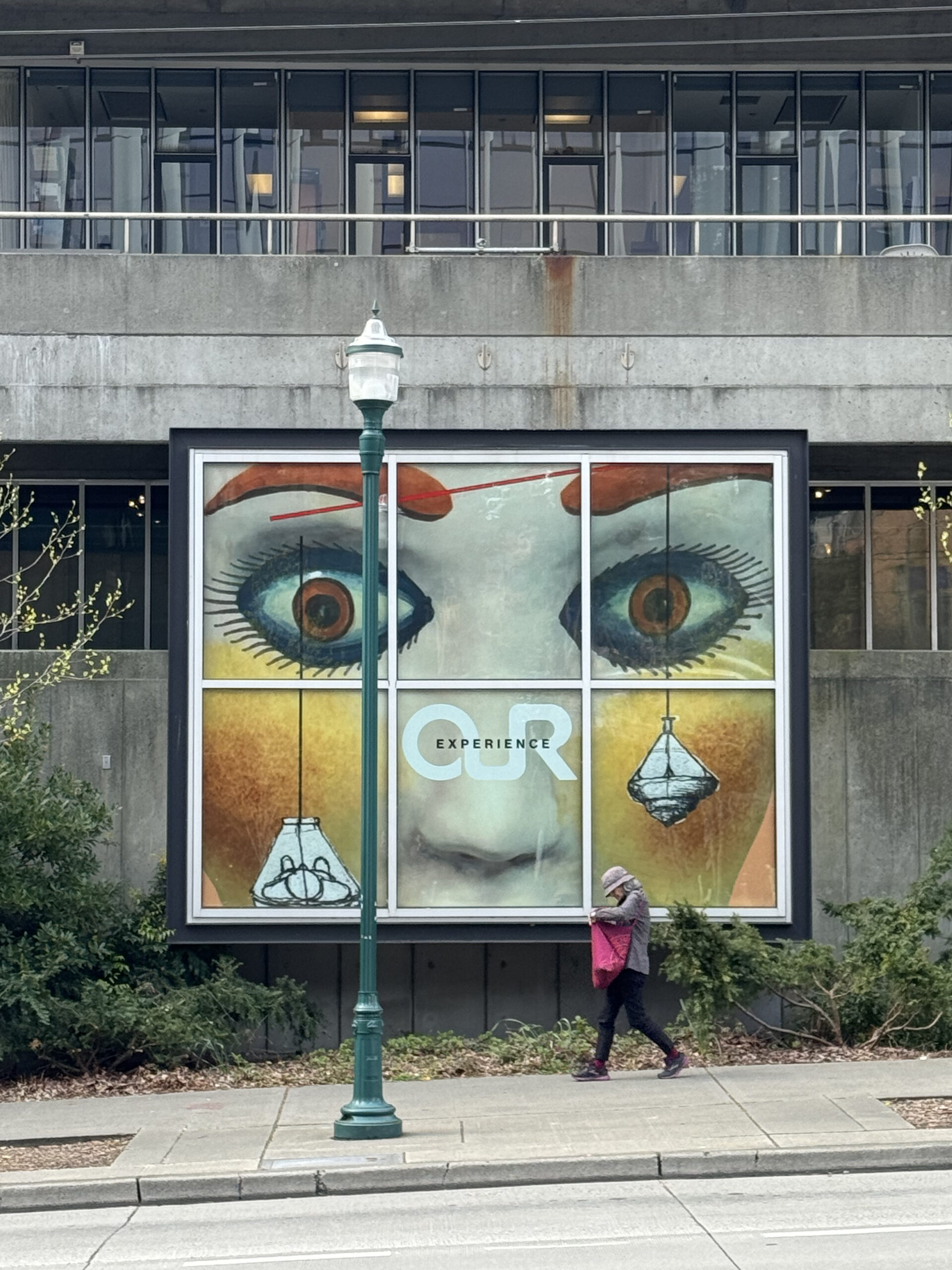 Outside view of a graphic of eyes posted in a window