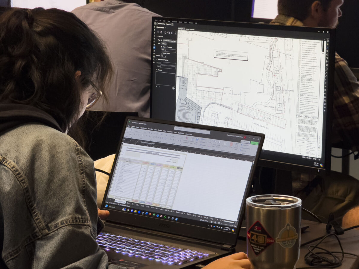 Student using a computer with maps on the screen