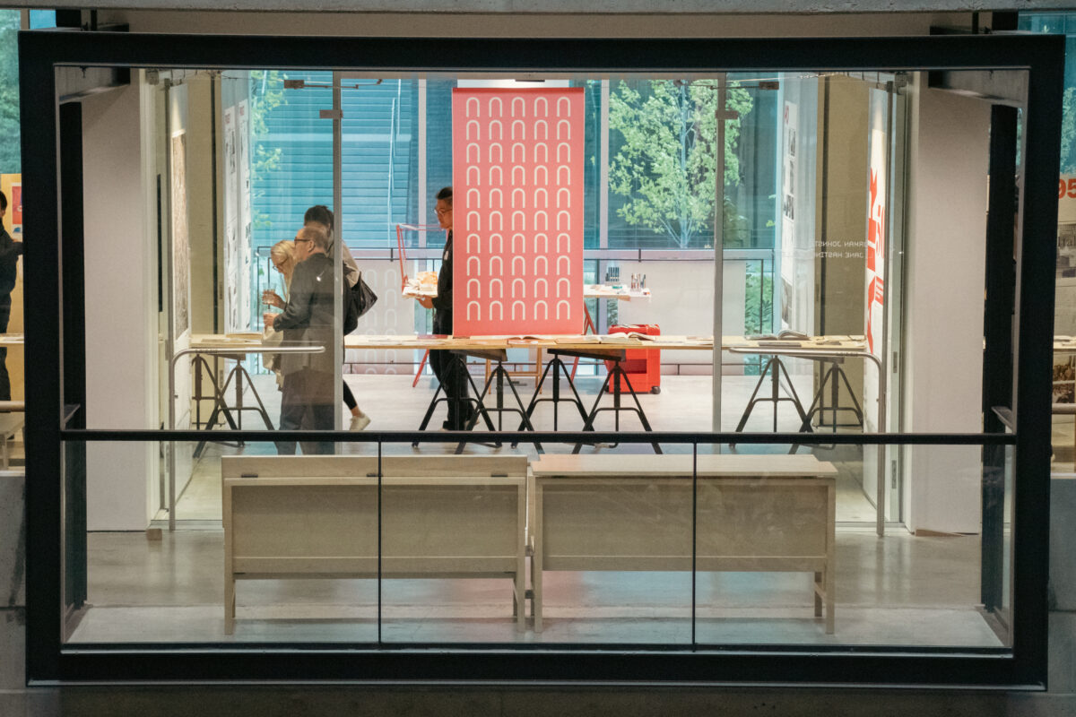 Outside view of people looking at exhibits in a brightly lit gallery