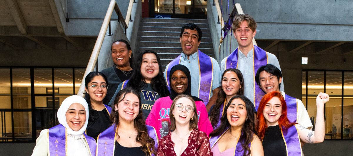 Group of students standing on stairs and smiling