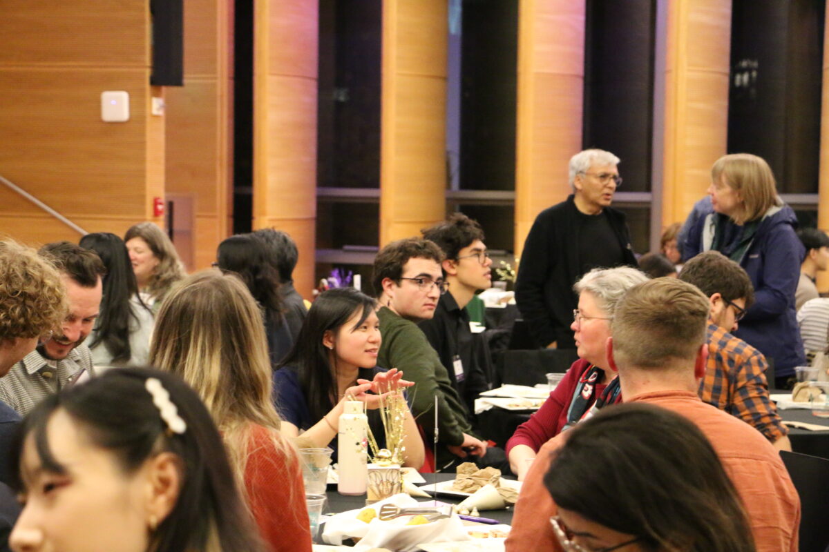 A room filled with mentors and mentees conversing