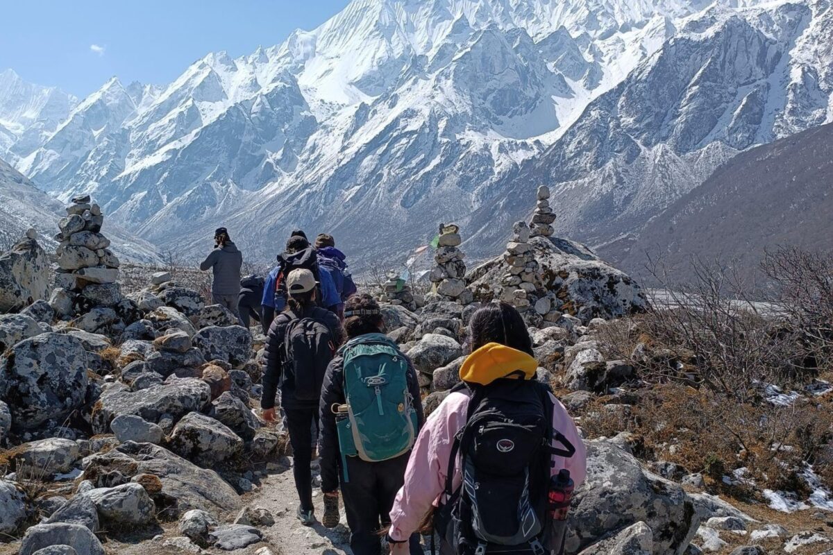 Students walking on a rocky trail in a mountain range