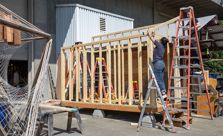 CBE staff building a shed outside of Gould Hall.