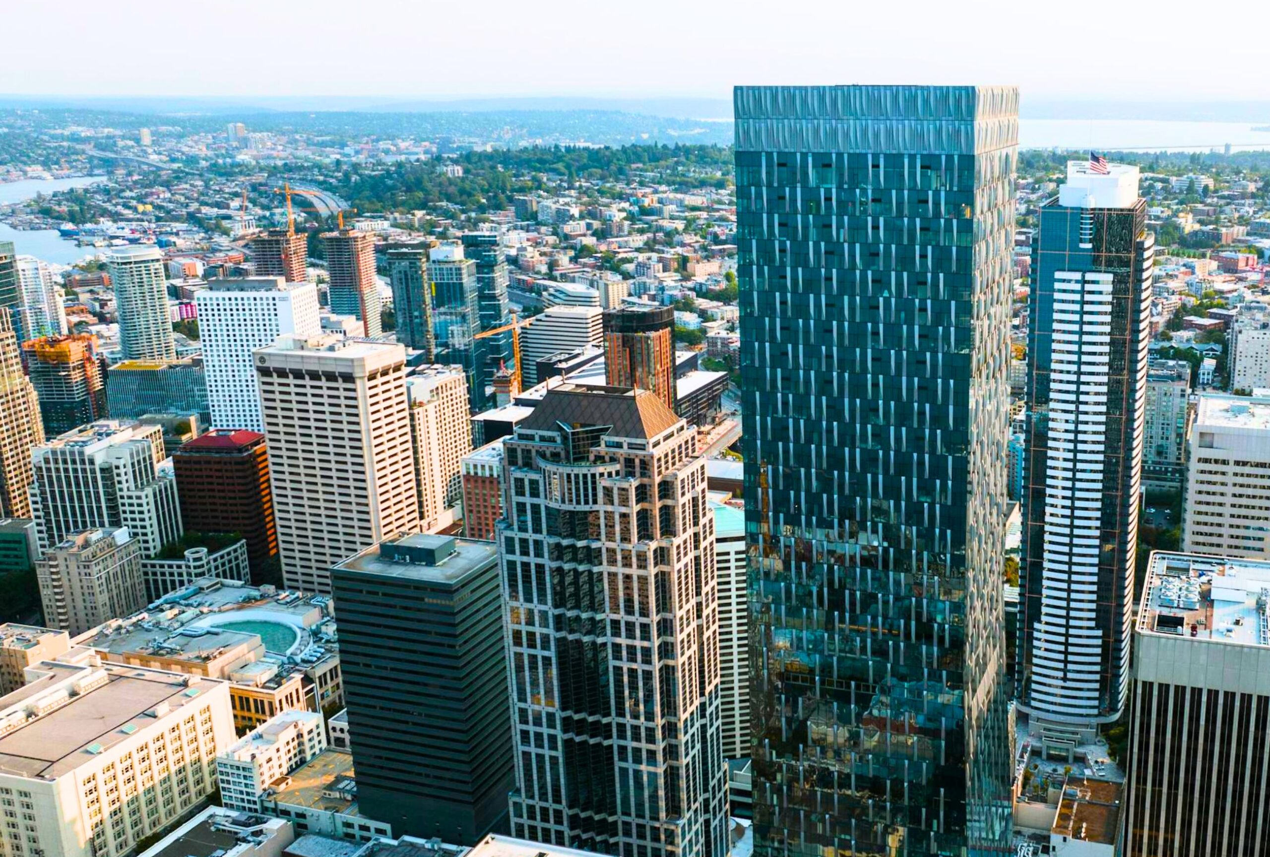 : Drone shot of the top of a skyscraper in a city.