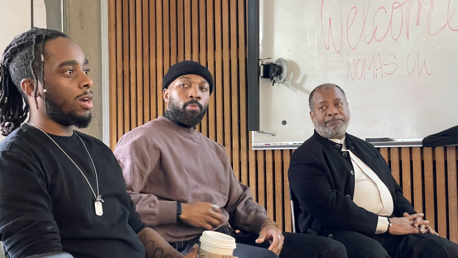 Three people sitting and talking