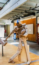 Cardboard figure in football attire doing the Heismann pose