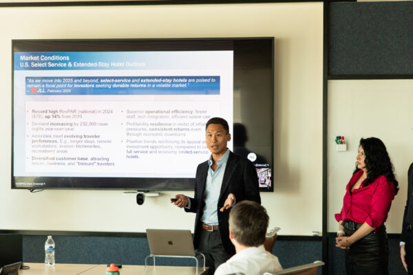Student speaking in front of a screen
