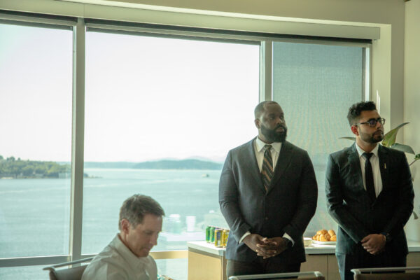 Students standing in front of a window with the puget sound