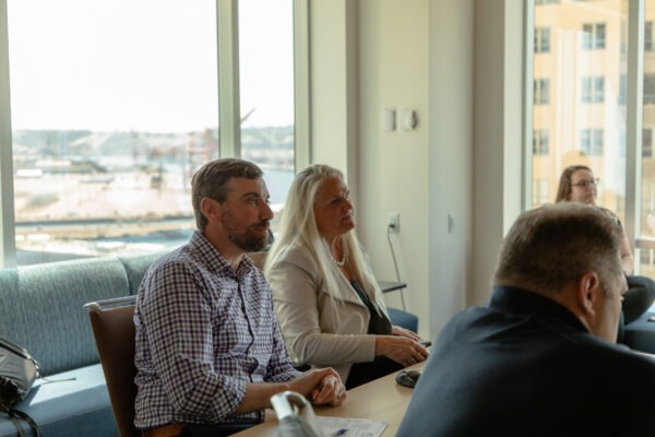 People listening intently to student presenters