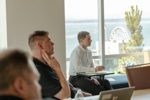 People intently listening to student presenters