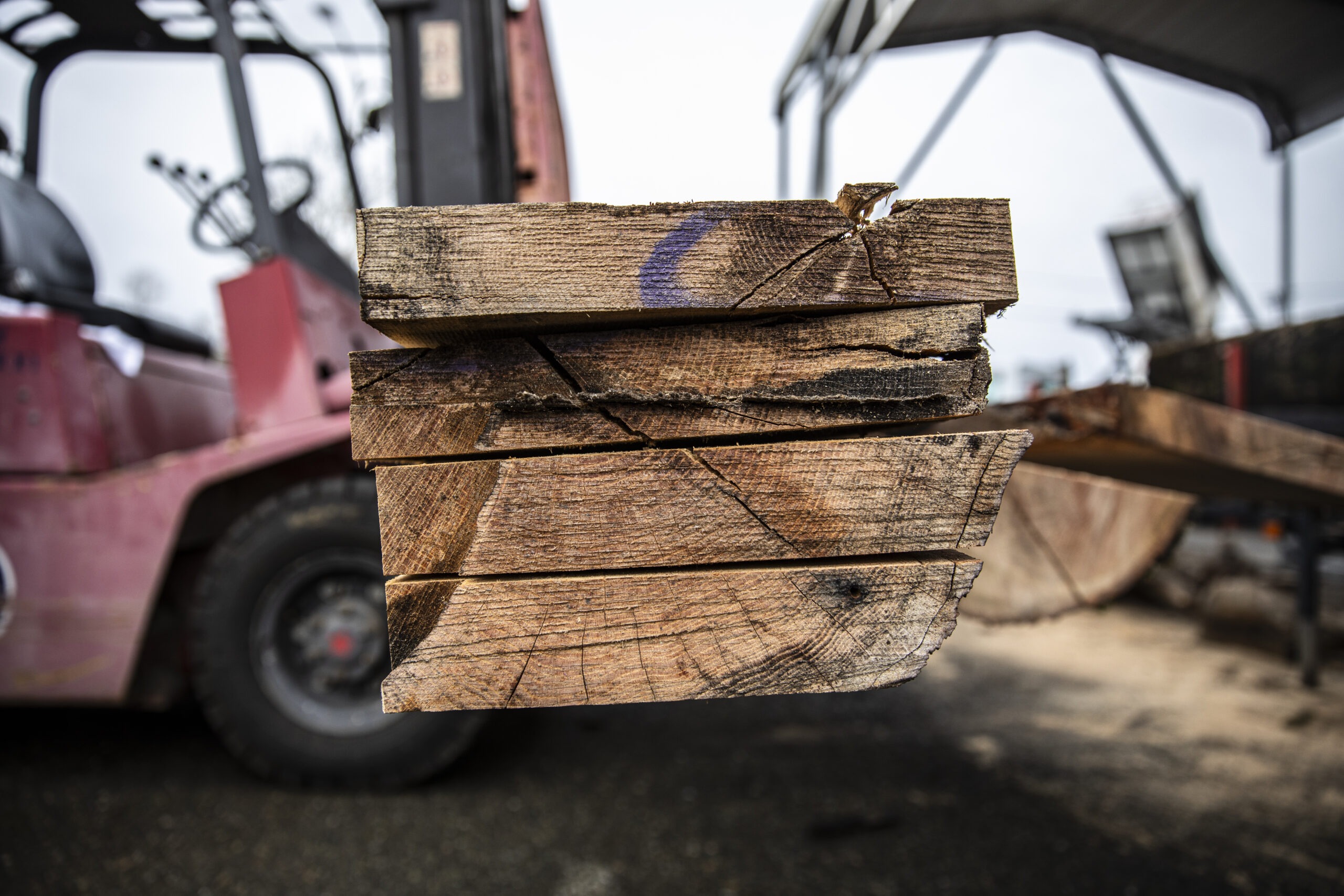 Close-up view of stacked and freshly milled wood planks, revealing the natural grain and texture of the lumber.