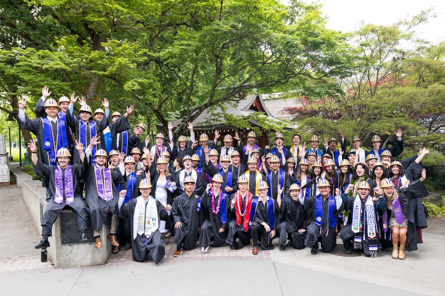 Group of construction management students at graduation cheering