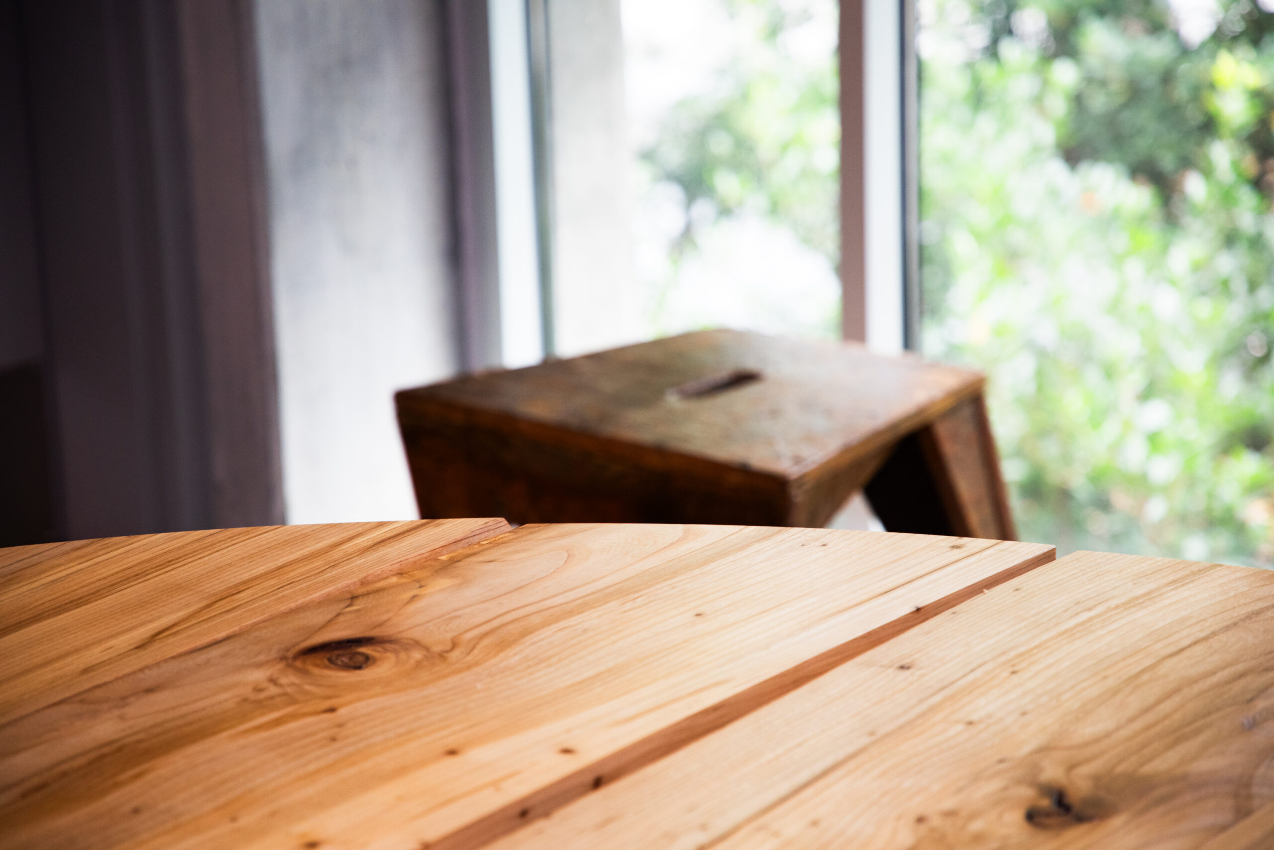 Close up of table edge with bench in background