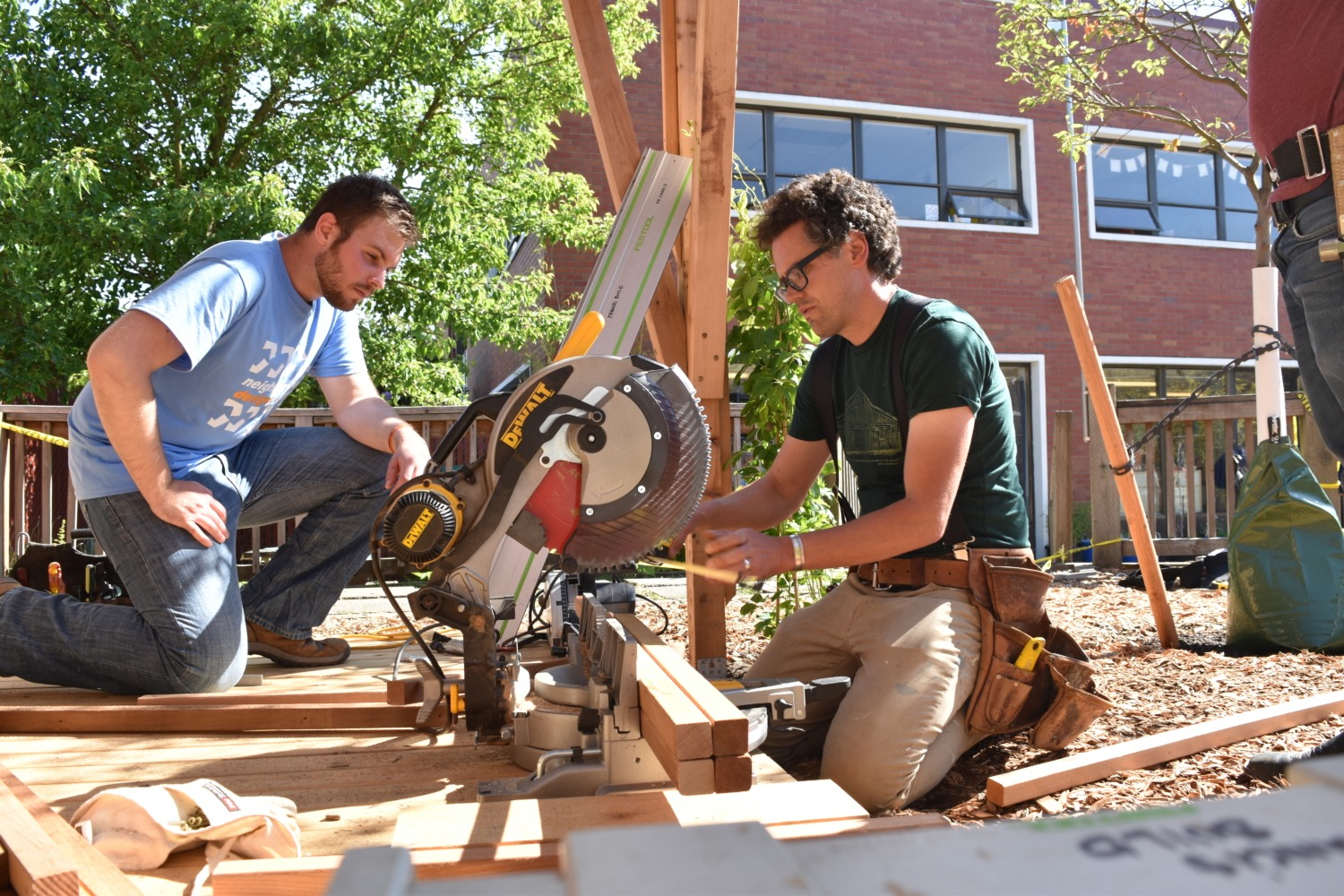 Instructor using saw in front of student