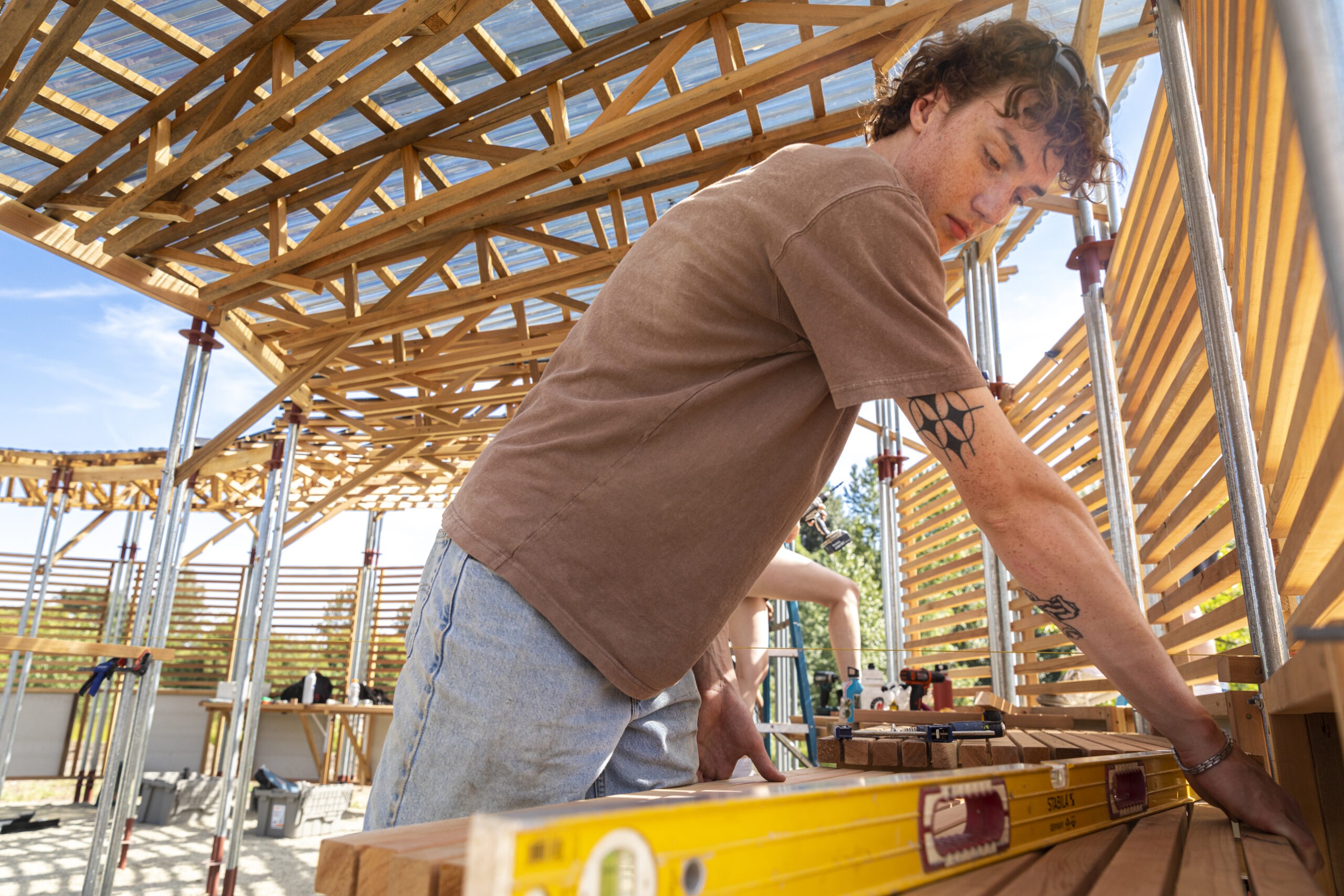 Student working under a wooden structure