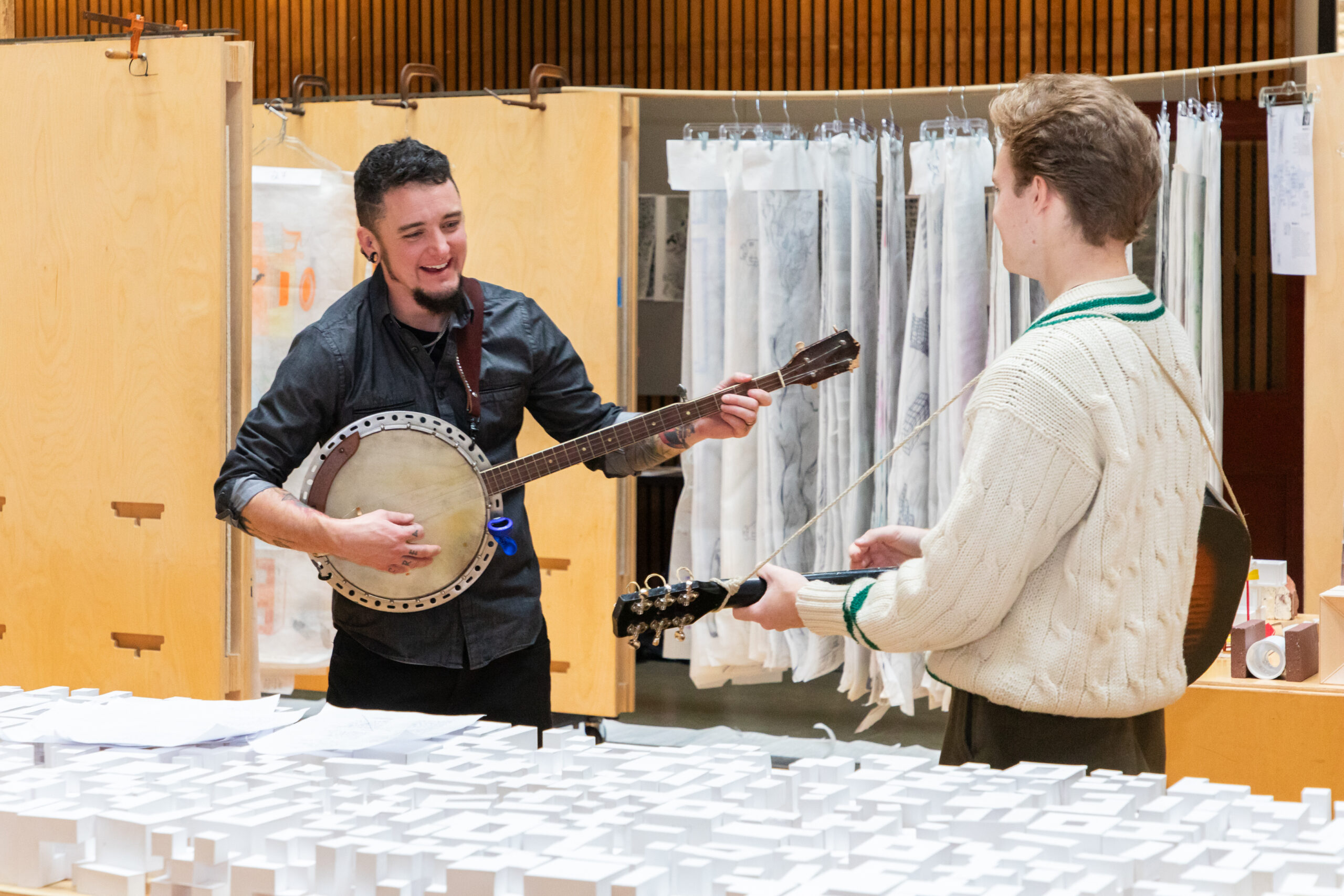 Students playing string instruments by geometric models