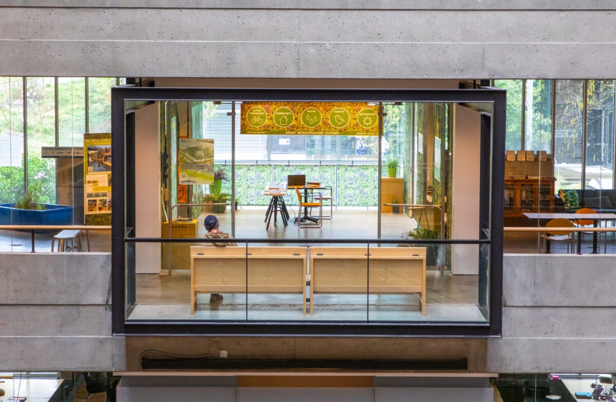 Outside view of room with many windows and exhibit material inside