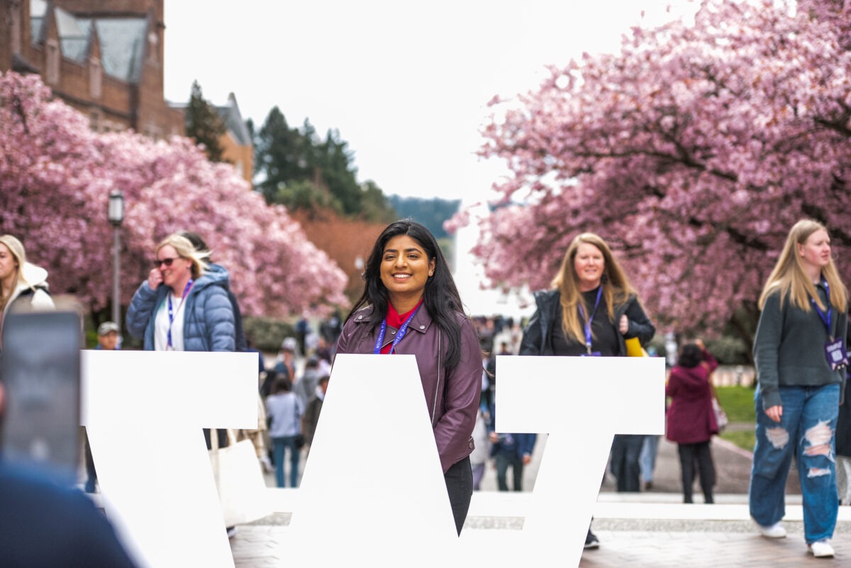 Student smiling behind block W on Admitted Student Preview Day