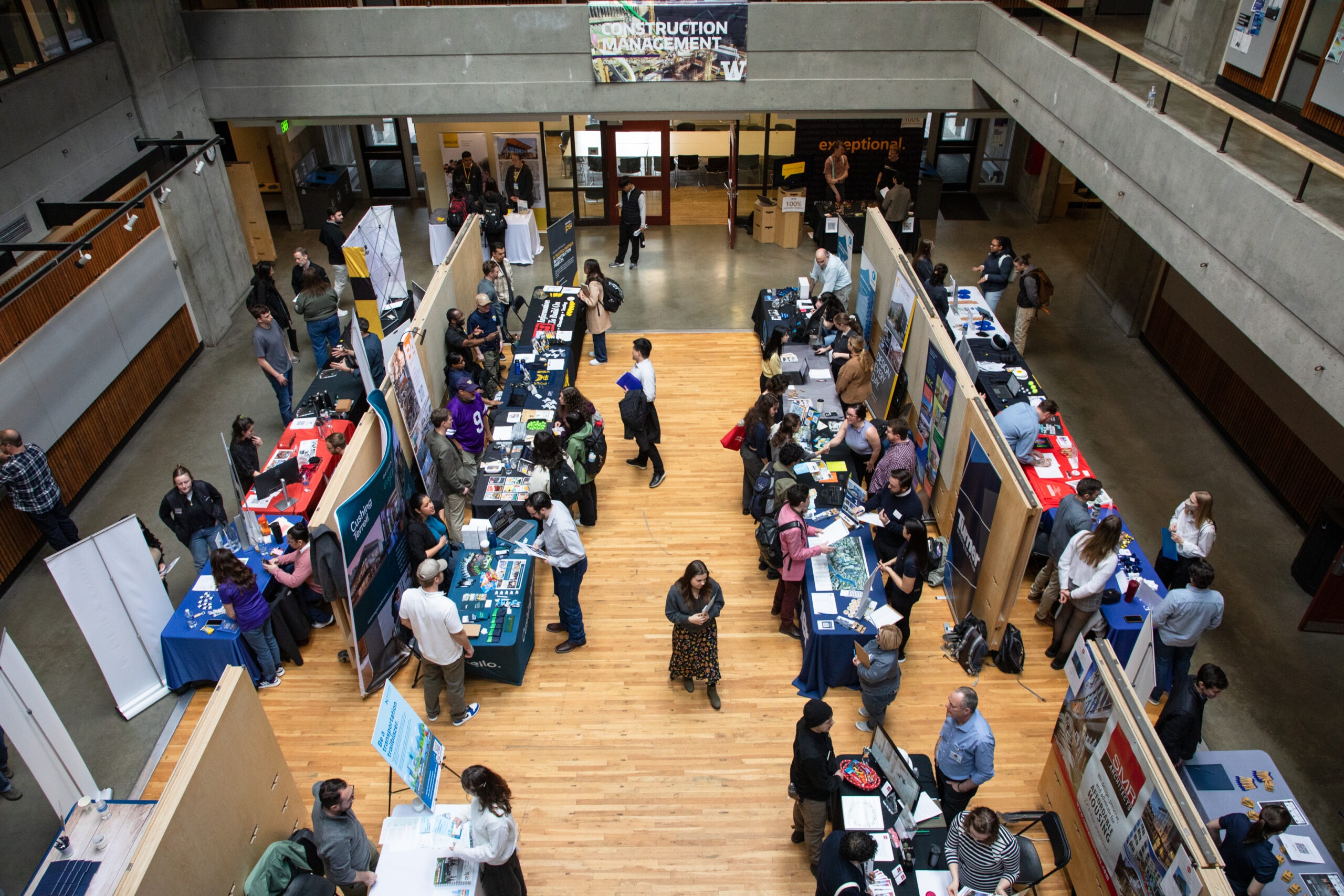 Court full of students speaking to employers at booths