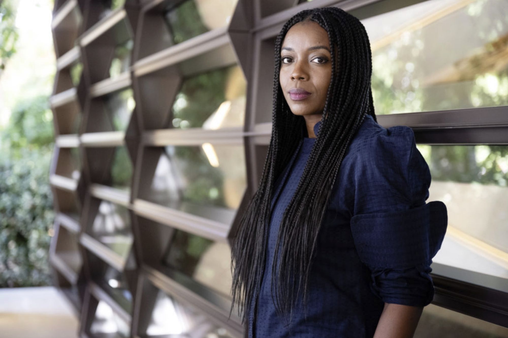Mariam Issoufou standing in front of wooden slats