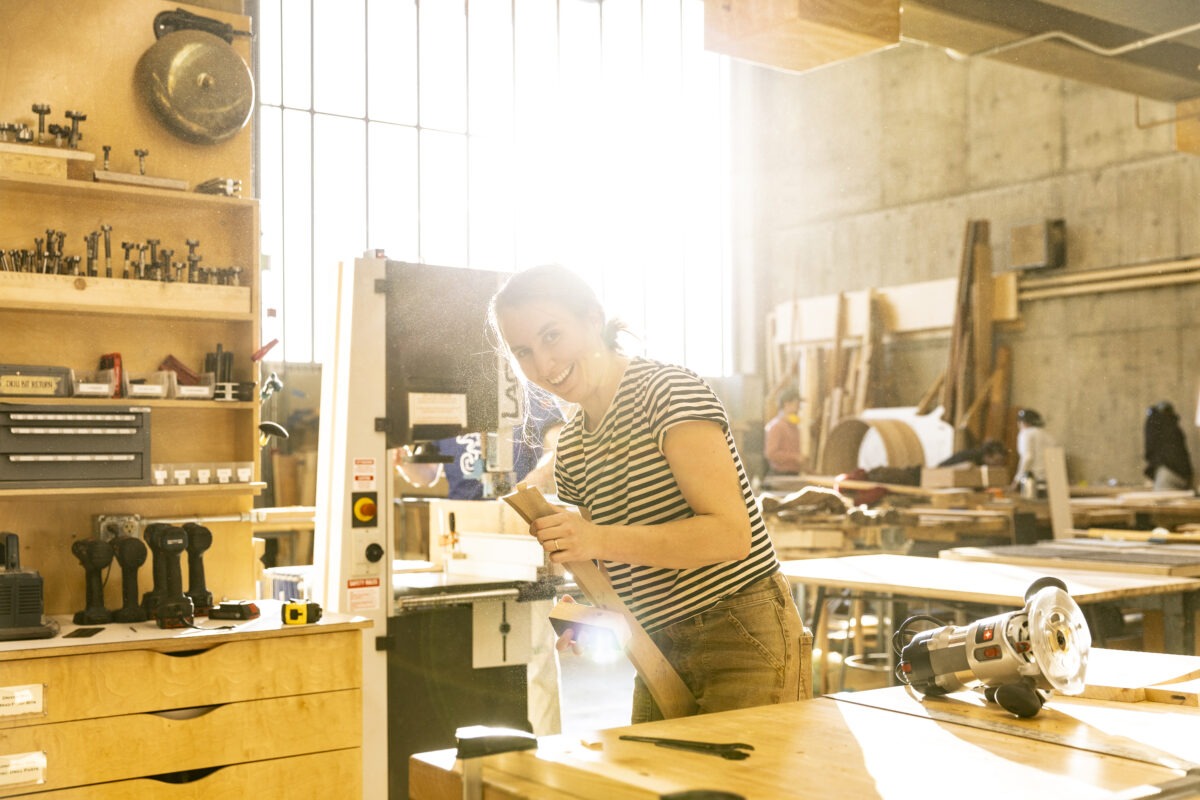 Girl smiling in a wood shop