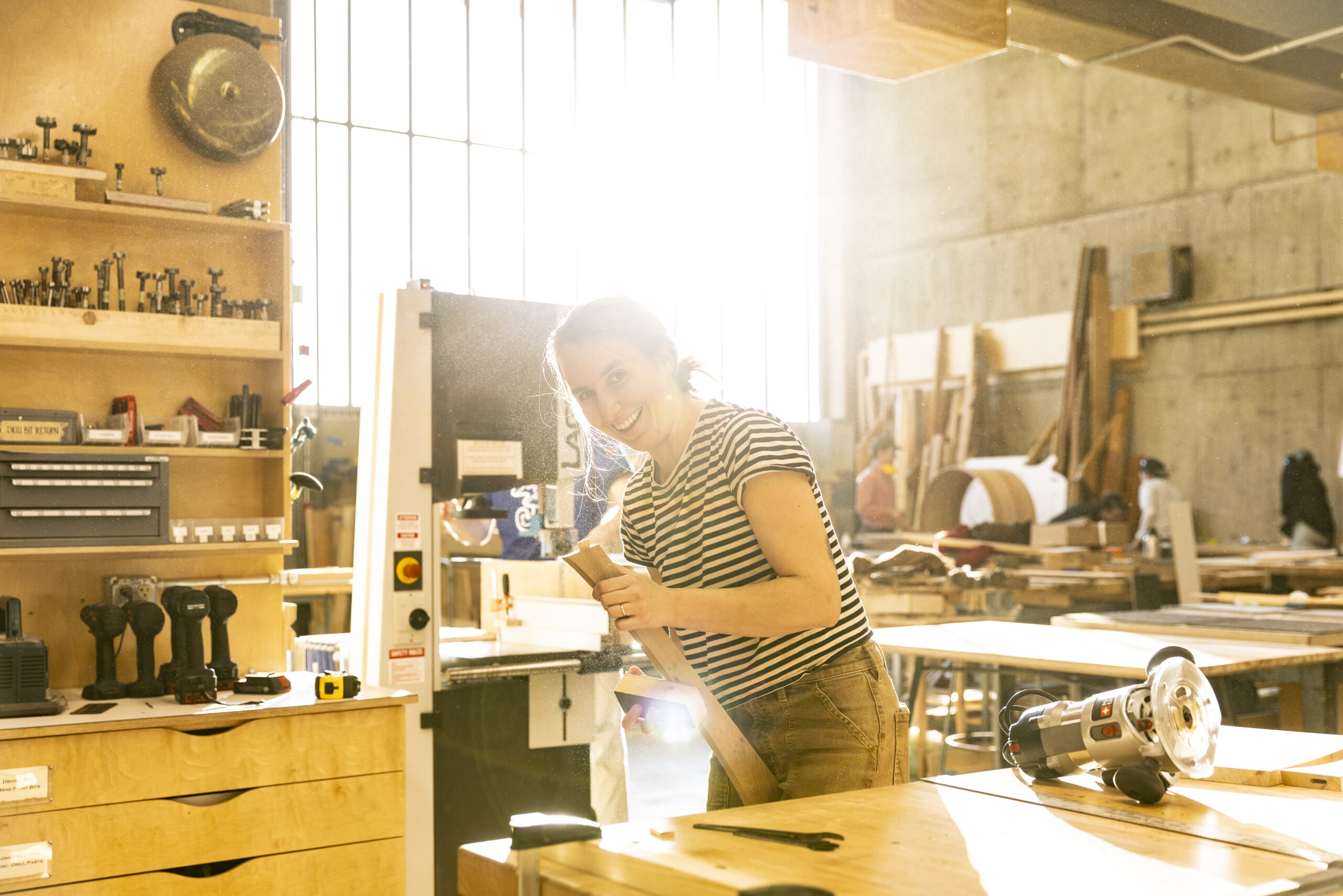 Girl smiling in a wood shop