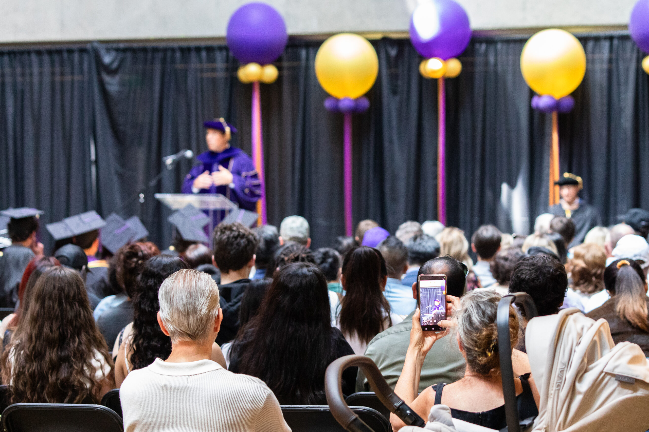 Person records graduation ceremony on phone