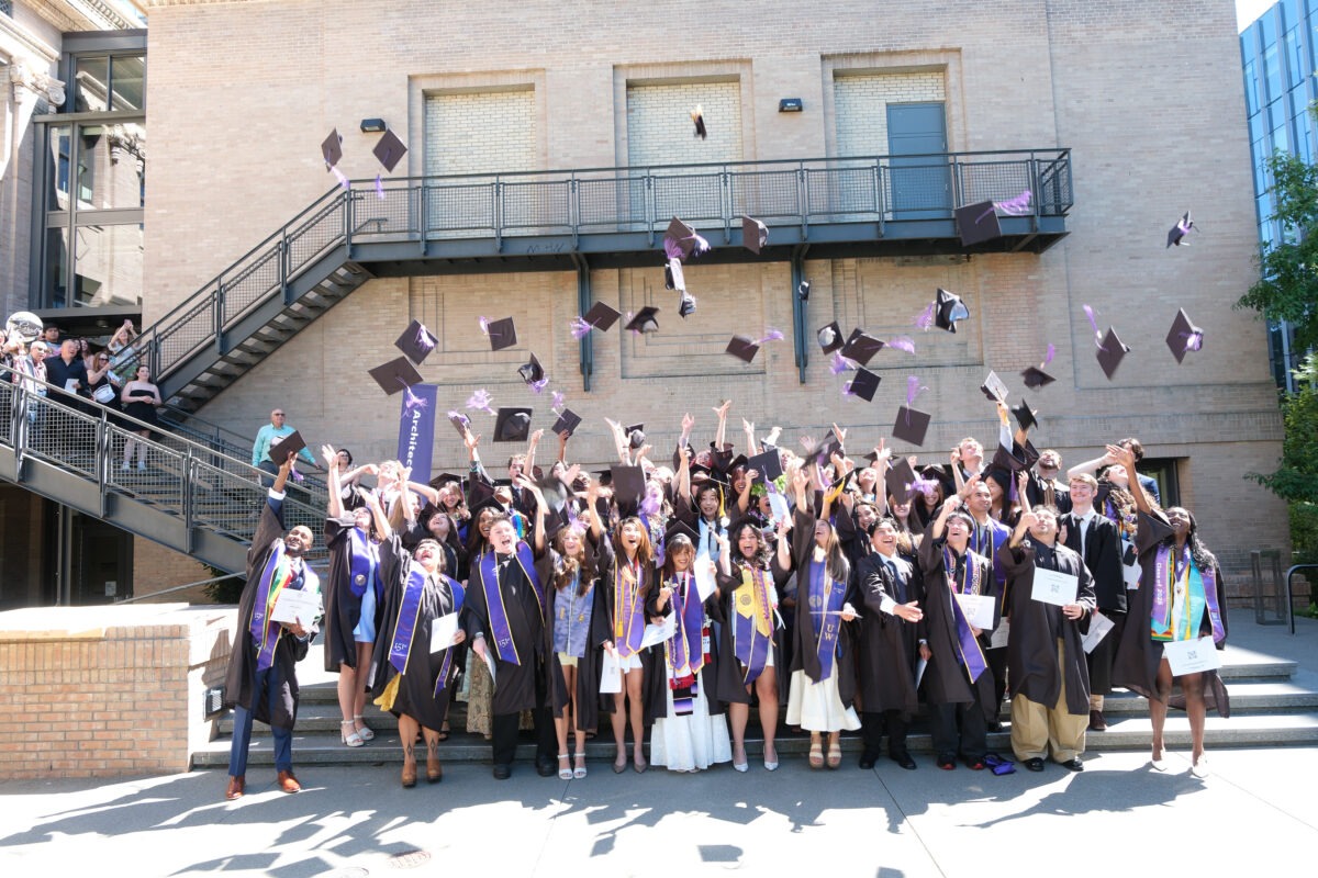 Students throwing caps in air