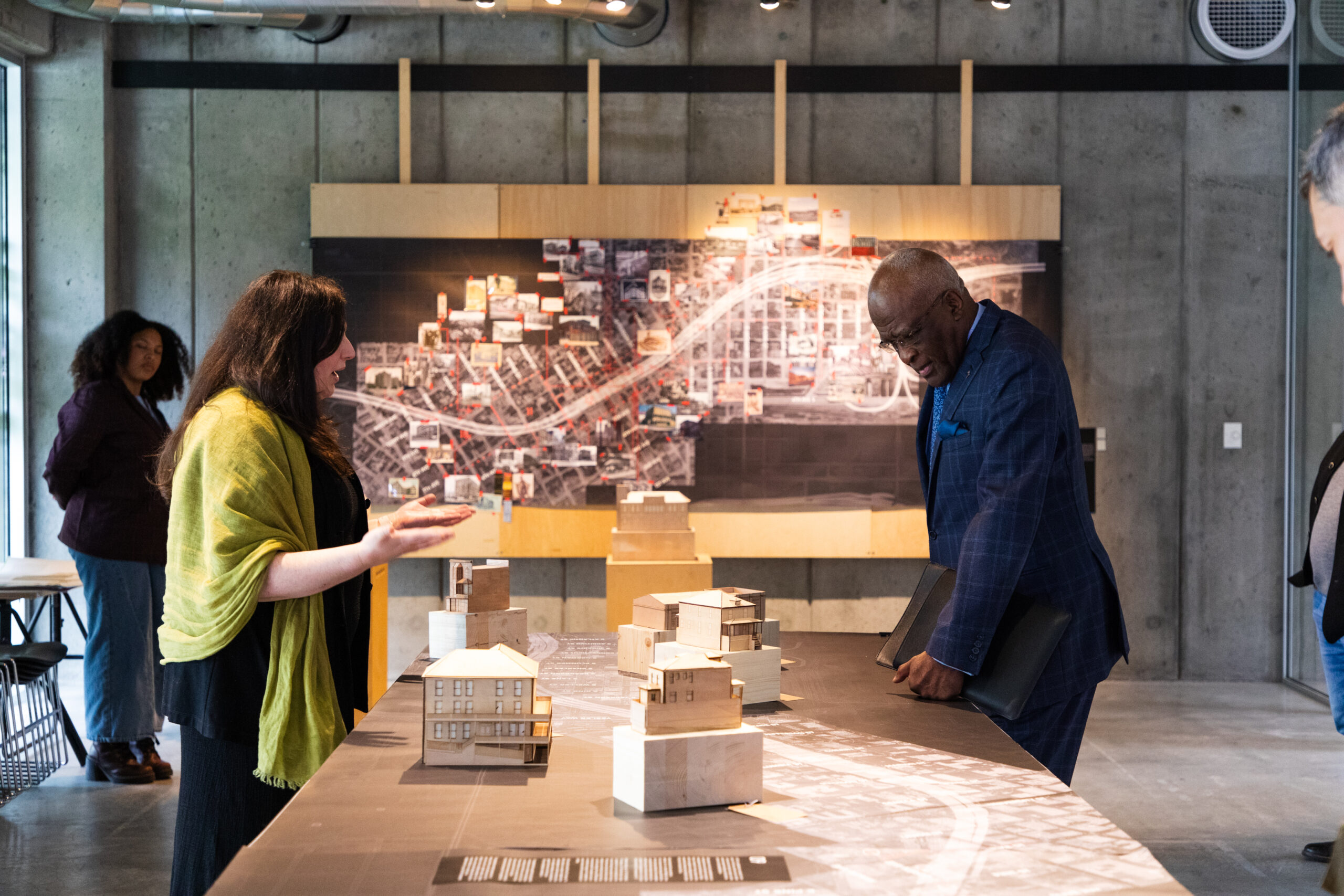 two people look at wooden models on a map of I-5