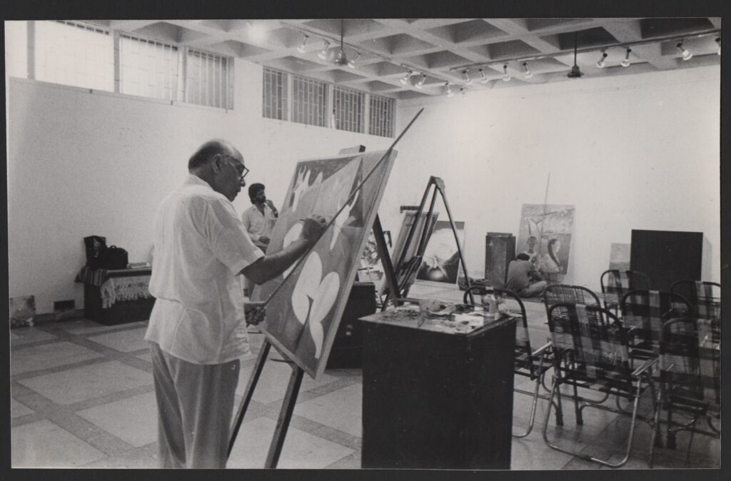 Aditya painting on an easel